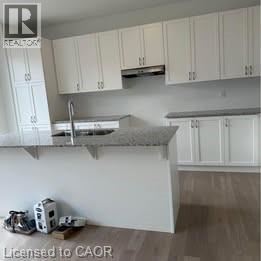 Kitchener apartment for rent - A kitchen with white cabinets and a countertop.
