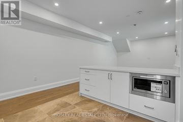 Toronto (Mount Pleasant East) apartment for rent - A kitchen with white cabinets and a microwave oven.