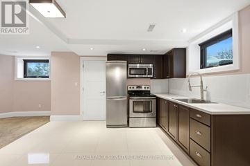 Toronto (East York) apartment for rent - A modern kitchen with a stainless steel oven and microwave.