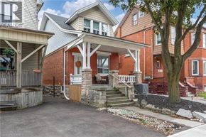 Hamilton apartment for rent - A house with a porch and a tree in front.