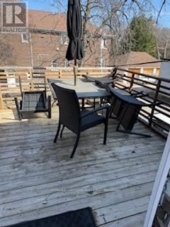 Toronto (Mount Pleasant East) apartment for rent - A wooden deck with a table and chairs.