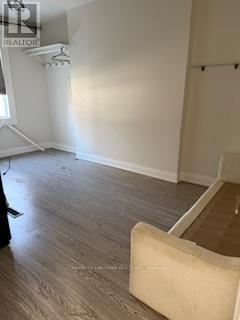 Toronto (Mount Pleasant East) apartment for rent - A room with a wooden floor and a chair.