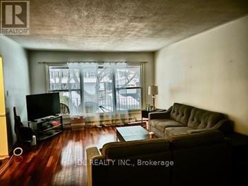 Toronto (L'amoreaux) apartment for rent - A living room with a grey couch and a television.