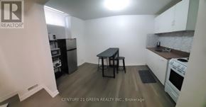 Whitby (Pringle Creek) apartment for rent - A kitchen with a table and chairs in the middle of the room.