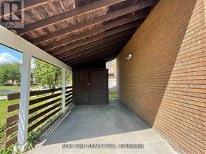 Markham (Bullock) apartment for rent - A covered walkway with a wooden ceiling and brick walls.