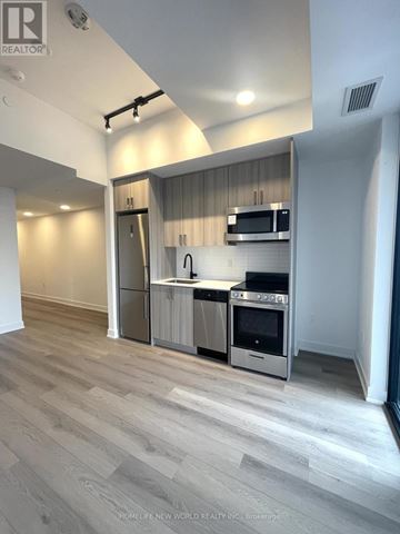 Toronto (Dovercourt-Wallace Emerson-Junction) condo for rent - A modern kitchen with a refrigerator, oven, and microwave.