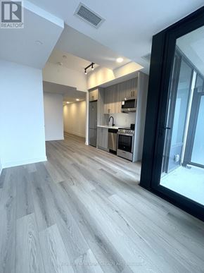 Toronto (Dovercourt-Wallace Emerson-Junction) condo for rent - A modern kitchen with wooden flooring and a large window.