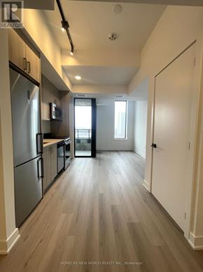 Toronto (Dovercourt-Wallace Emerson-Junction) condo for rent - A kitchen with wooden floors and stainless steel appliances.