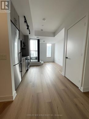 Toronto (Dovercourt-Wallace Emerson-Junction) condo for rent - A kitchen with a refrigerator, cabinets, and a microwave.