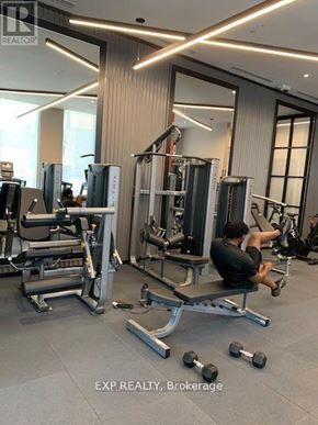 Hamilton (Beasley) condo for rent - A man is working out in a gym with a variety of equipment.