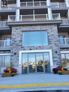 Southgate condo for rent - A stone building with a glass door and windows.
