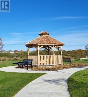 Southgate condo for rent - A gazebo with a bench in front of it is situated in a park.