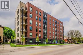 Waterloo condo for rent - A tall apartment building with balconies on the second floor.