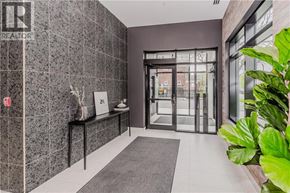 Waterloo condo for rent - A hallway with a bench and a plant on the right side.