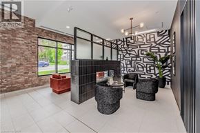Waterloo condo for rent - A modern living room with a brick wall and a black and white patterned wallpaper.