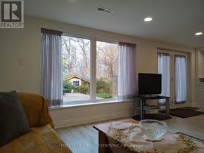 Markham (Thornhill) apartment for rent - A living room with a couch, a table, and a television.