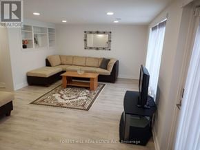 Markham (Thornhill) apartment for rent - A living room with a couch, a coffee table, and a television.