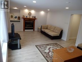 Markham (Thornhill) apartment for rent - A living room with a couch, a fireplace, and a rug.