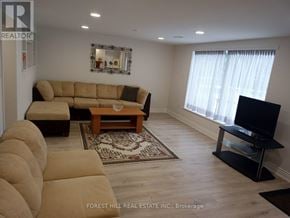 Markham (Thornhill) apartment for rent - A living room with a couch, a coffee table, and a flat screen TV.