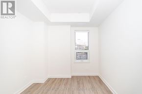 Ottawa condo for rent - A white room with a picture frame on the wall and a wooden floor.