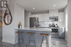 Ottawa condo for rent - A modern kitchen with a bar area and a large mirror on the wall.