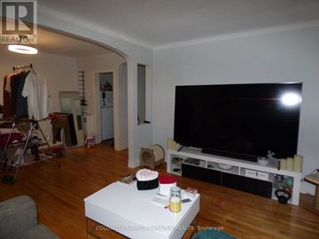 Ottawa multi-family for rent - A living room with a white coffee table and a black television.