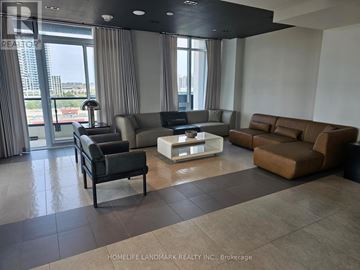 Richmond Hill (South Richvale) condo for rent - A living room with a black leather chair and a white coffee table.