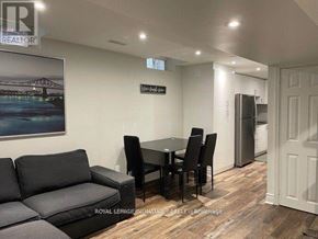 Vaughan (Vaughan Grove) apartment for rent - A living room with a black couch and a dining table.