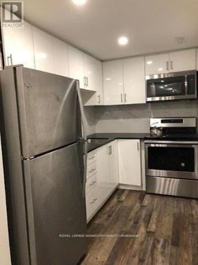 Vaughan (Vaughan Grove) apartment for rent - A kitchen with a stainless steel refrigerator, microwave, and oven.