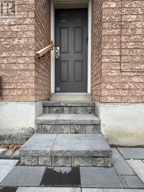 Vaughan (Maple) apartment for rent - A black door with a brass handle is on a brick wall.