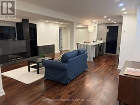 Vaughan (Maple) apartment for rent - A living room with a blue couch and a fireplace.