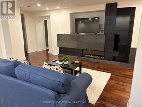 Vaughan (Maple) apartment for rent - A living room with a blue couch and a television.