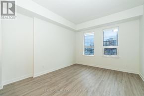 Ottawa condo for rent - A room with a window and a wooden floor.