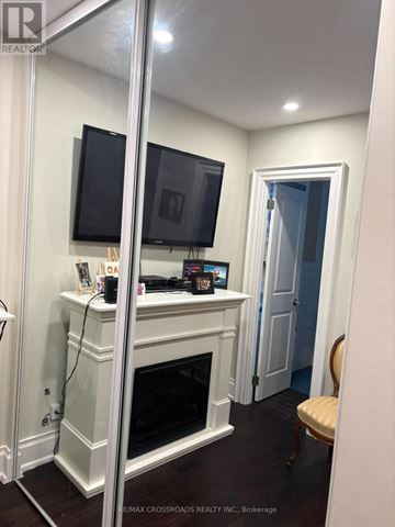 Toronto (Clairlea-Birchmount) apartment for rent - A living room with a fireplace and a television above it.
