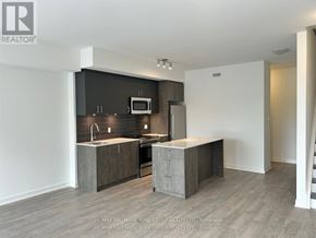 Toronto (Birchcliffe-Cliffside) townhouse for rent - A modern kitchen with a sink, microwave, and oven.