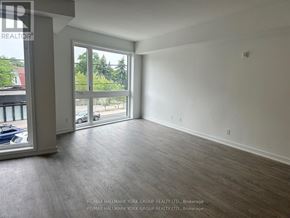 Toronto (Birchcliffe-Cliffside) townhouse for rent - A spacious room with a view of the outside through a large window.