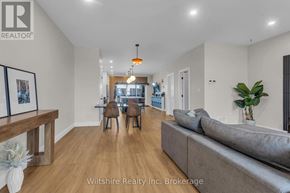 Tillsonburg townhouse for rent - A living room with a grey couch and a wooden table.