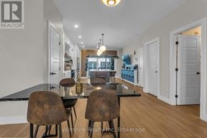 Tillsonburg townhouse for rent - A dining room with a table and chairs is shown.