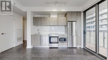 Toronto (Church-Yonge Corridor) condo for rent - A modern kitchen with a stainless steel refrigerator and oven.