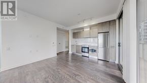 Toronto (Church-Yonge Corridor) condo for rent - A spacious kitchen with stainless steel appliances and a dining area with a table and chairs.