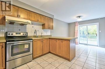 Toronto (Steeles) apartment for rent - A kitchen with wooden cabinets and a stainless steel oven.