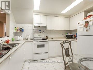 Richmond Hill (Devonsleigh) apartment for rent - A kitchen with white cabinets and appliances.