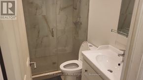 Toronto (Clairlea-Birchmount) apartment for rent - A bathroom with a toilet, sink, and shower.