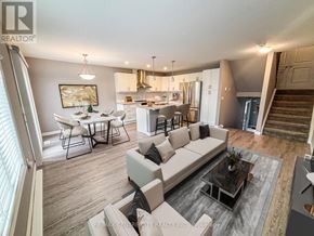 London South (South W) townhouse for rent - A well-lit, modern living room with a kitchen in the background.