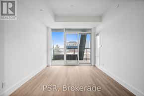 Toronto (Bayview Village) condo for rent - A room with a large window and wooden flooring.