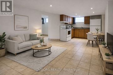 Burlington (Mountainside) apartment for rent - A well-lit, modern living room with a kitchen in the background.