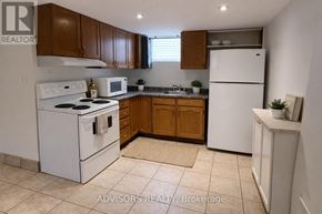Burlington (Mountainside) apartment for rent - A kitchen with white appliances and brown cabinets.
