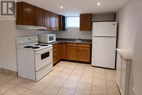 Burlington (Mountainside) apartment for rent - A kitchen with white appliances and brown cabinets.