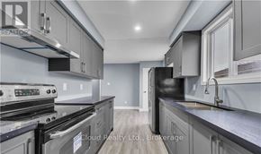 London East (East D) apartment for rent - A modern kitchen with stainless steel appliances and grey cabinets.
