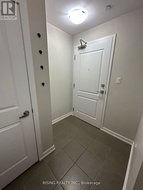 Hamilton (Stoney Creek) condo for rent - A hallway with a white door and a white door with a peephole.